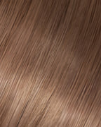 A swatch of Dottie's straight, light ash brown hair texture, showcasing the softness and shine of the hair extension.