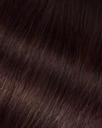 A swatch of a dark brown Betsy hair extension, showcasing its texture and color details.