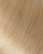 A swatch of a light golden blonde hair extension showing a long, straight line of smooth, shiny hair.
