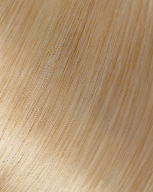A swatch of a light golden blonde hair extension, showing a long, straight line of smooth, shiny hair.