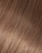 A swatch of Dottie's straight, light ash brown hair texture, showcasing the softness and shine of the hair extension.