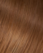 A swatch of Veronica's straight, dark golden blonde hair extension, showcasing its smooth texture and shine.