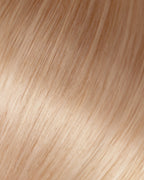 A swatch of Dixie light beige blonde hair extensions showcasing fine, wavy texture and natural shine.