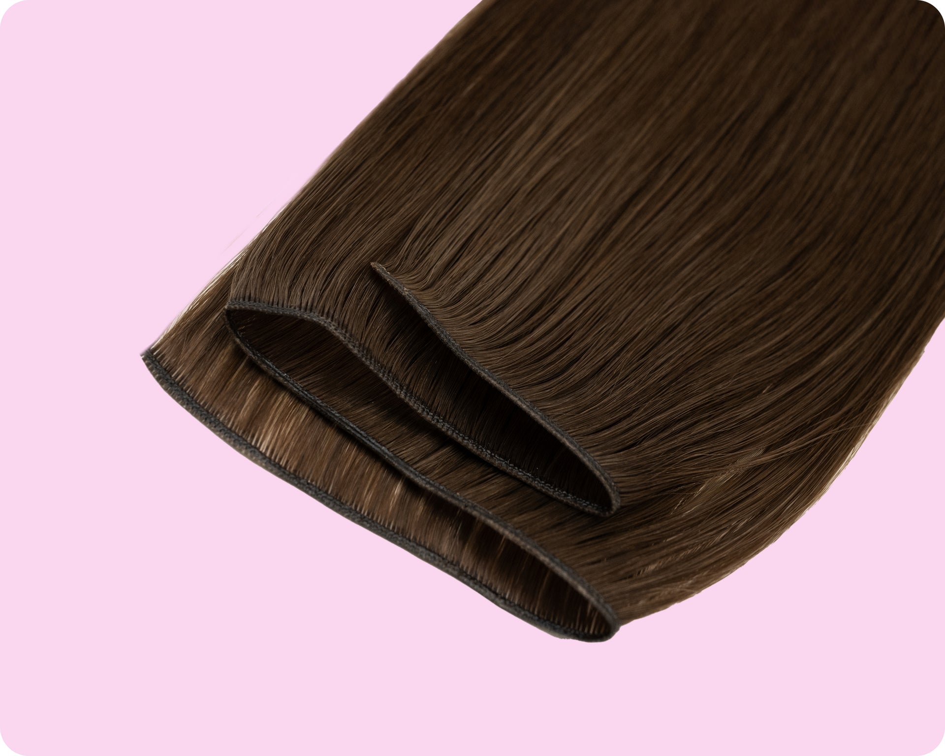 Straight brown weft hair extensions on a pastel pink background, showing neatly sewn double wefts