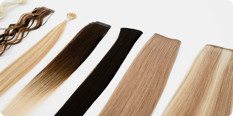 A variety of hair extensions are displayed on a white surface, showcasing different types and styles.